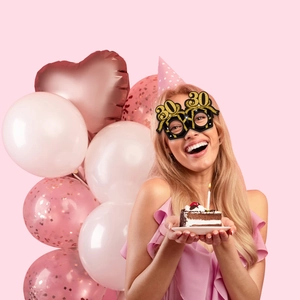 Smiling woman wearing black and gold glitter 30th birthday glasses at a festive party