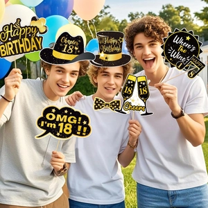 Close-up of 18th birthday photo booth props in black and gold style for party fun