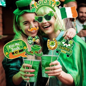 Women using St. Patrick's Day photo booth props including lucky clover glasses and party hats