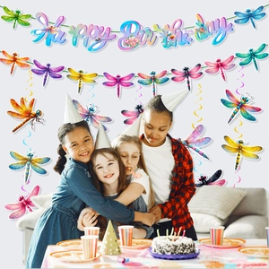 Colorful dragonfly birthday party banner and hanging spirals with happy kids
