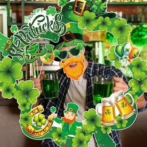 Happy St. Patrick's Day photo booth props set with clover frame in festive bar setting