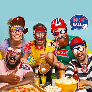 Group of friends using colorful baseball themed photo booth props at a lively party