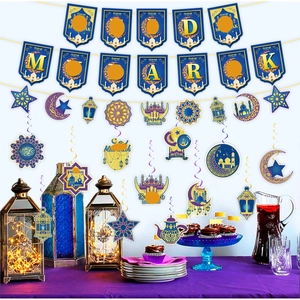 Detail of blue and gold Eid Mubarak party decorations with moon and mosque hanging spirals