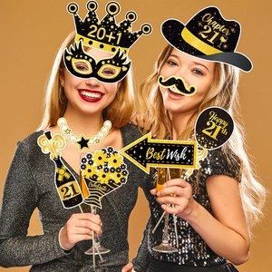 Models displaying 21st birthday party photo booth props in black and gold glitter design