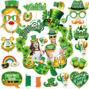 St. Patrick's Day photo booth props set with shamrock glasses and Irish party decorations