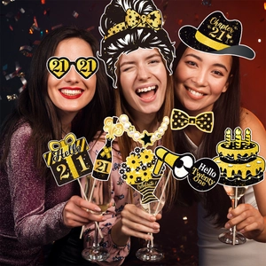 Three models using black and gold 21st birthday party photo booth props with glitter