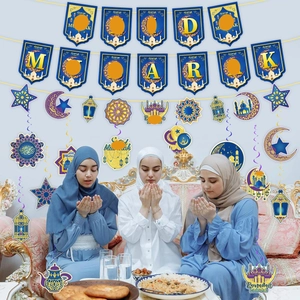 Blue and gold Eid Mubarak party decorations with hanging star and moon spiral swirls