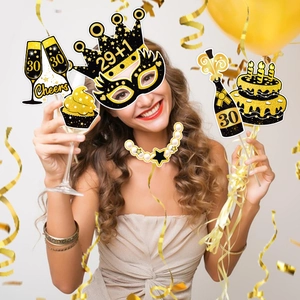 30th birthday photo booth props with black and gold glitter crowns and champagne signs