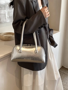 Silver metallic shoulder bag with high-shine texture and sleek baguette design