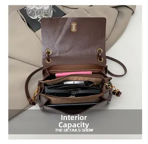 Detail view of the retro crossbody bag's internal compartments and storage capacity