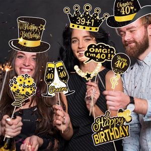 Three people holding 40th birthday party photo booth props in black and gold theme