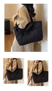 Detail of black wave quilted tote bag featuring a side zipper pocket and glossy finish