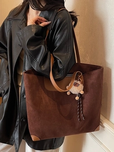 Vintage large brown faux suede tote bag with plush charm shown on female model
