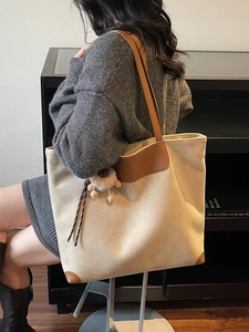 Beige faux suede large tote bag with brown leather straps shown on model for daily commute