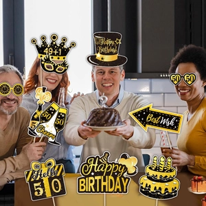 50th birthday party photo booth props with black and gold glitter accessories and models