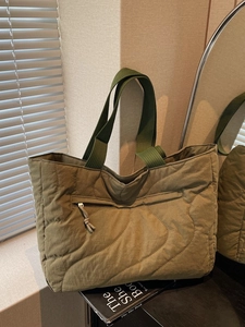 Olive green quilted tote bag with wave stitching and functional front zipper pocket