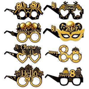 Set of eight black and gold 80th birthday party paper glasses with glittery designs
