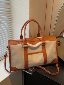 Retro canvas and brown leather travel duffel bag with dual handles and shoulder strap