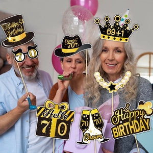 Seniors using 70th birthday photo props in black and gold with glitter finish