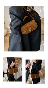 Detailed view of glossy brown baguette bag with golden lock and smooth patent finish