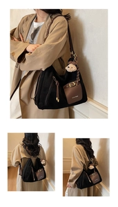 Détail du cabas en daim avec poche en cuir marron et breloque petit ours