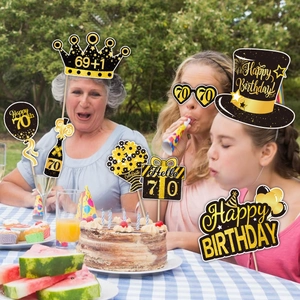 Detail of 70th birthday photo booth props in black and gold for party celebrations