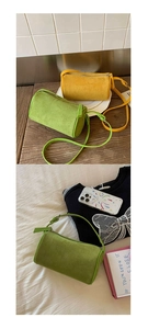 Detail of cylinder crossbody bags in lime green and yellow suede with top zipper