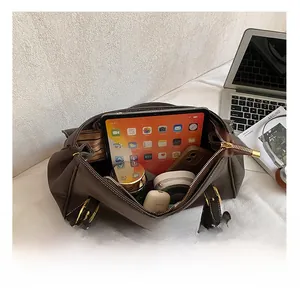 Macro shot showing the spacious interior of a dark brown leather tote with daily essentials