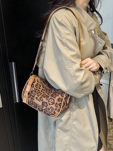 Retro leopard print Boston bag with brown leather trim and adjustable shoulder strap