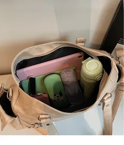 Interior view of spacious beige tote bag showing tablet, notebook, and water bottle