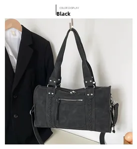 Detail of black matte Boston travel bag with side woven texture and silver metal hardware