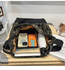 Spacious interior of camouflage canvas tote showing tablet, bottle and books
