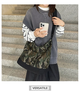 Detail of canvas camo tote bag with adjustable shoulder strap and black bottom panel
