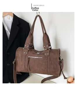 Close-up of retro brown gym bag with woven details, silver rivets, and crossbody strap