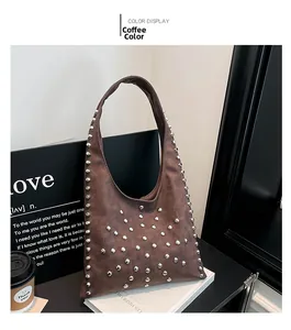 Detail view of coffee brown hobo bag with silver rivets placed on a book