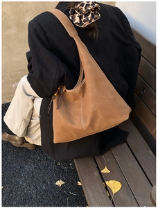Detail of vintage brown frosted tote bag with white stitching and tassel bead decor