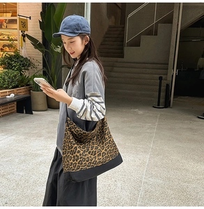 Detail of large leopard print tote bag with black splicing during street style wear