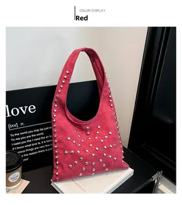 Detail of red suede underarm bag with silver rivets and trendy urban aesthetic