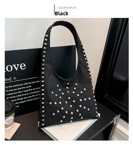 Detailed view of silver metal rivets on a trendy black nylon shoulder bag texture