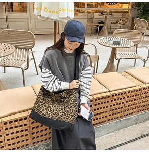 Detail of large leopard print canvas tote bag with reinforced bottom and wide shoulder strap