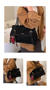 Detail of vintage black large tote bag with contrast stitching and bear charm