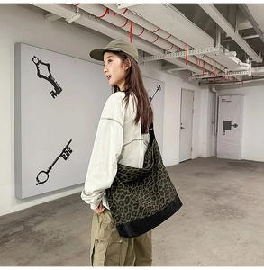 Detailed shot of large leopard print canvas tote bag with reinforced black base and strap