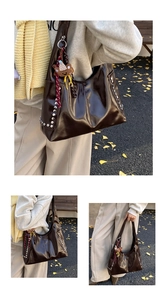 Detail of dark brown leather hobo bag with silver studs and cute bear pendant charm