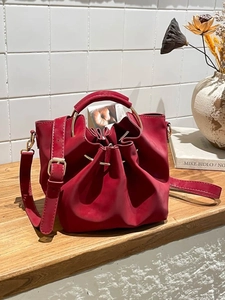 Retro red leather bucket bag with gold ring handle and drawstring for women