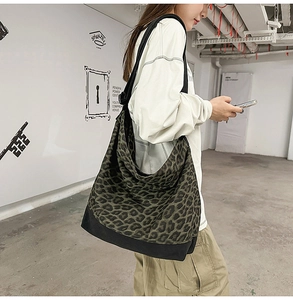 Detail of leopard print canvas tote bag with reinforced base and wide shoulder strap