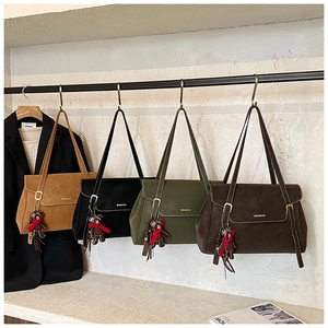 Detail of vintage tote bags in four colors with bear charms and metal hardware