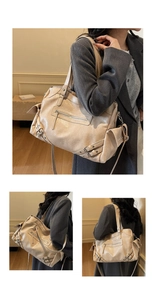 Detail view of large beige tote bag with buckle accents and vintage motorcycle design