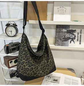 Detailed shot of leopard print canvas tote with adjustable strap on a vintage display