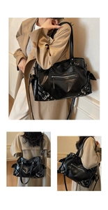 Detail of vintage black tote bag with silver hardware and retro motorcycle style texture