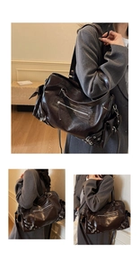 Detail of dark brown vintage faux leather tote bag with functional zippers and metal buckles